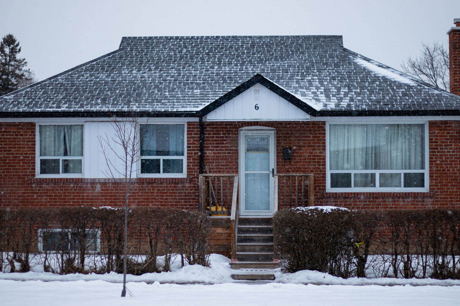 Brick bungalow in winter with snow on the ground, a typical Wisconsin home facing a long foreclosure timeline