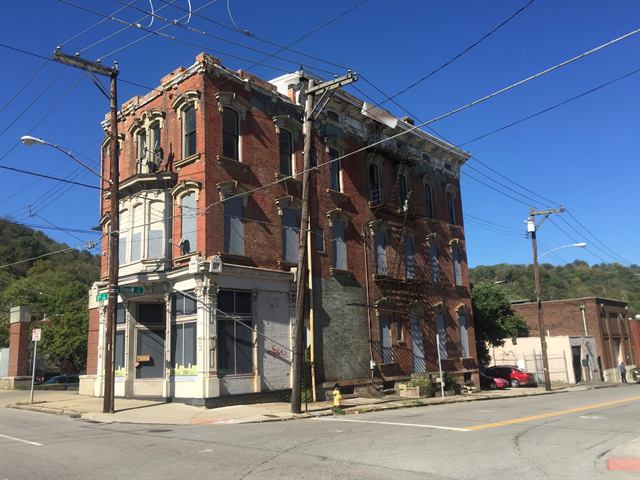 Older brick rental building on a city corner