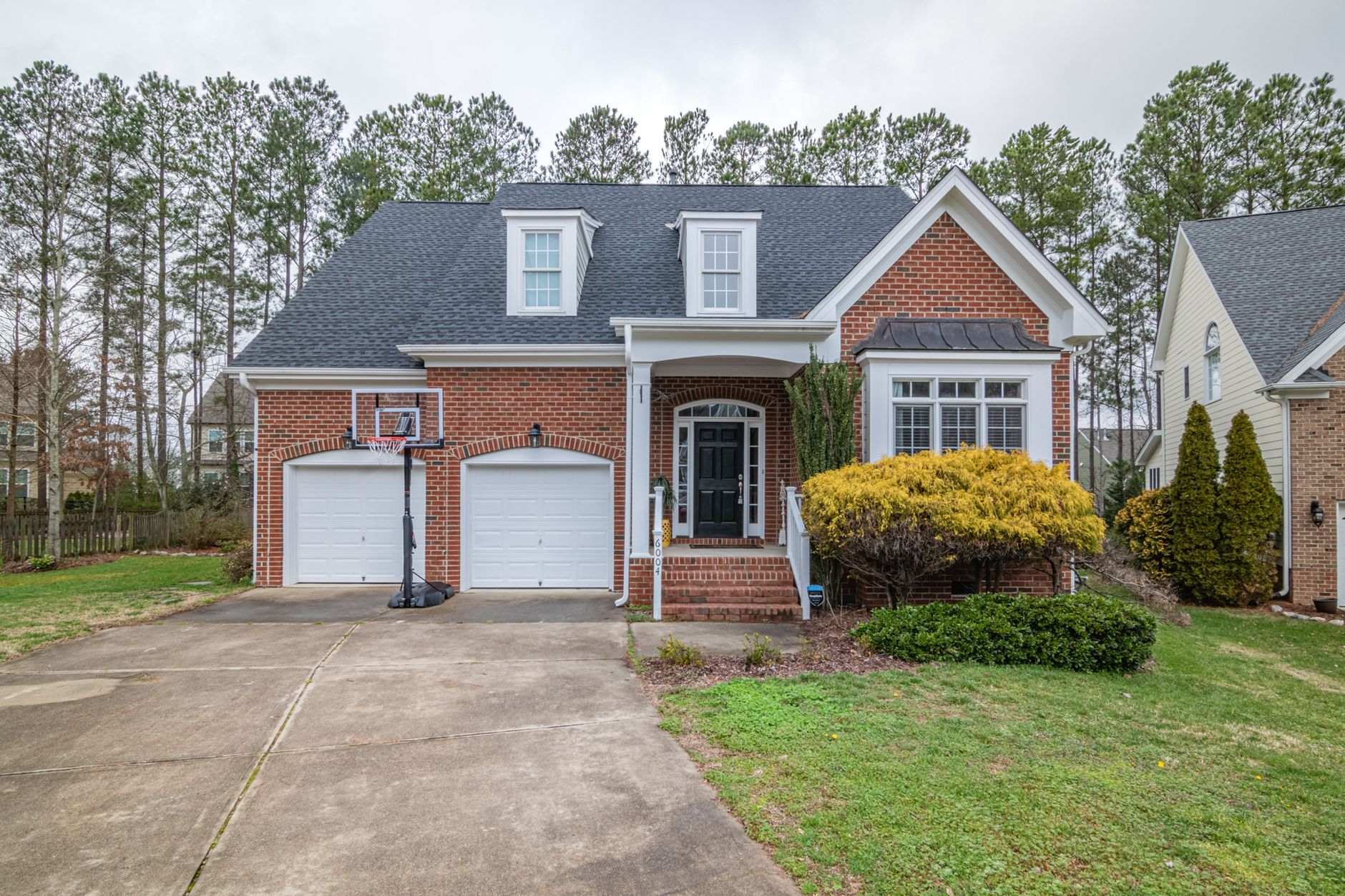 Brick two-story house with a small front yard, the kind of Georgia home at stake in a foreclosure