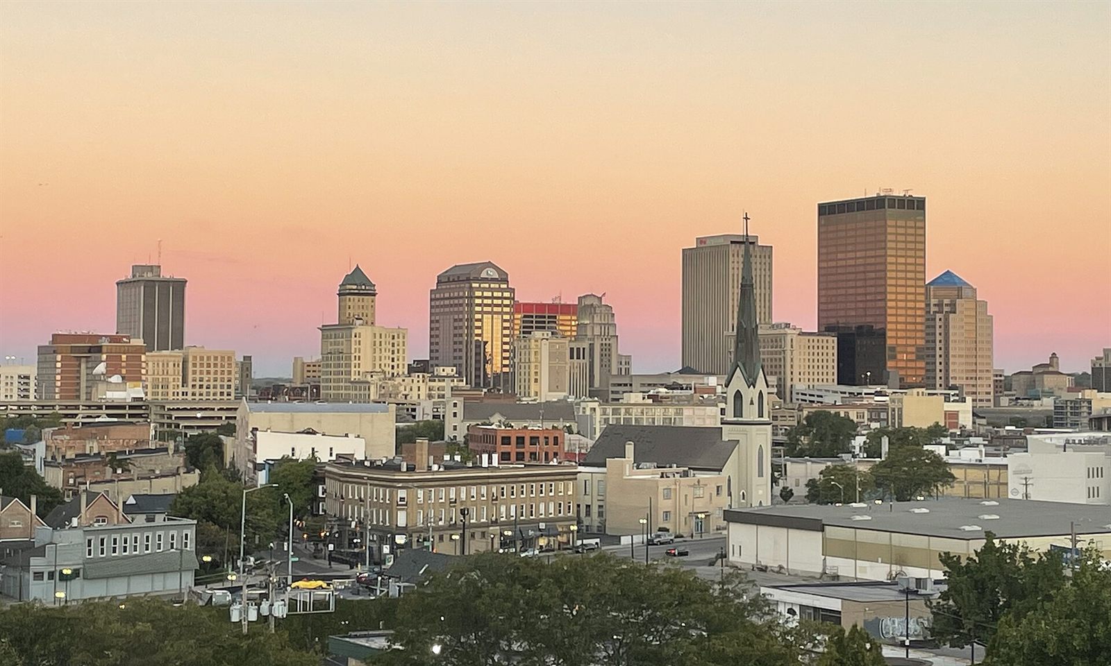 Downtown Dayton, Ohio skyline at sunset with high-rises and a church steeple