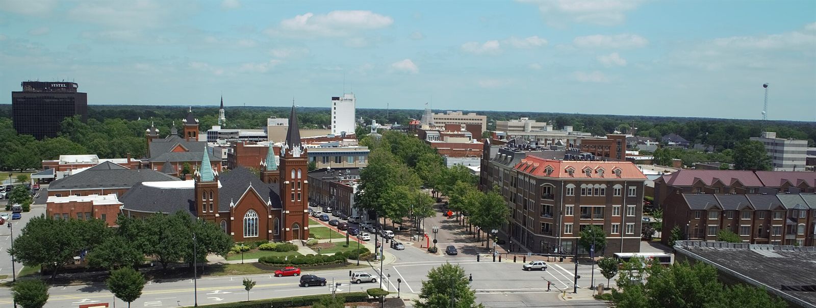 Aerial view of downtown Fayetteville, NC with historic churches and the city skyline