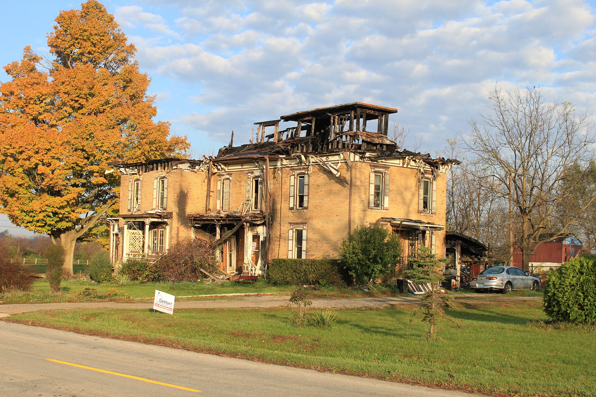 Brick house with severe fire damage to its roof structure