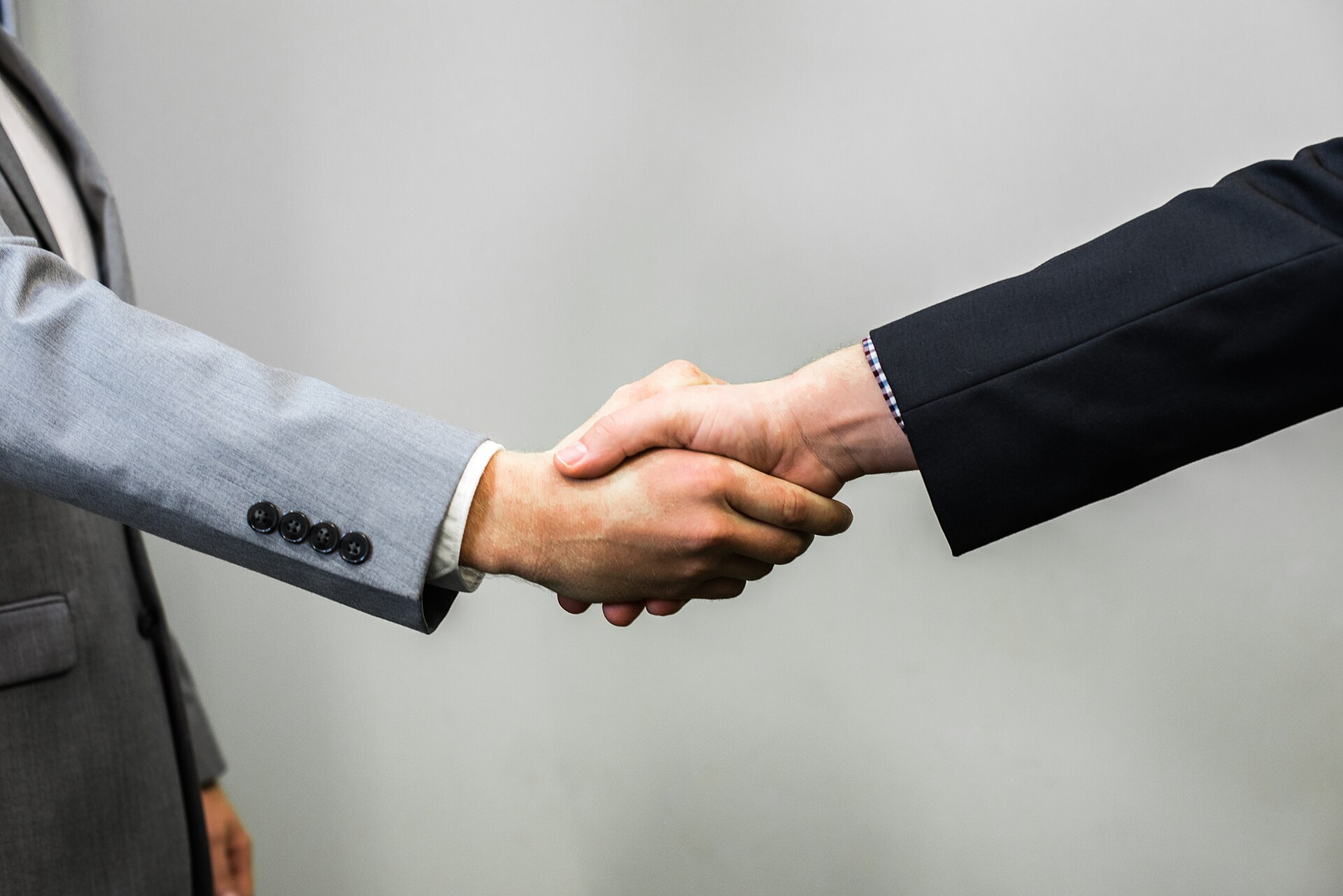 Two people shaking hands on an agreement