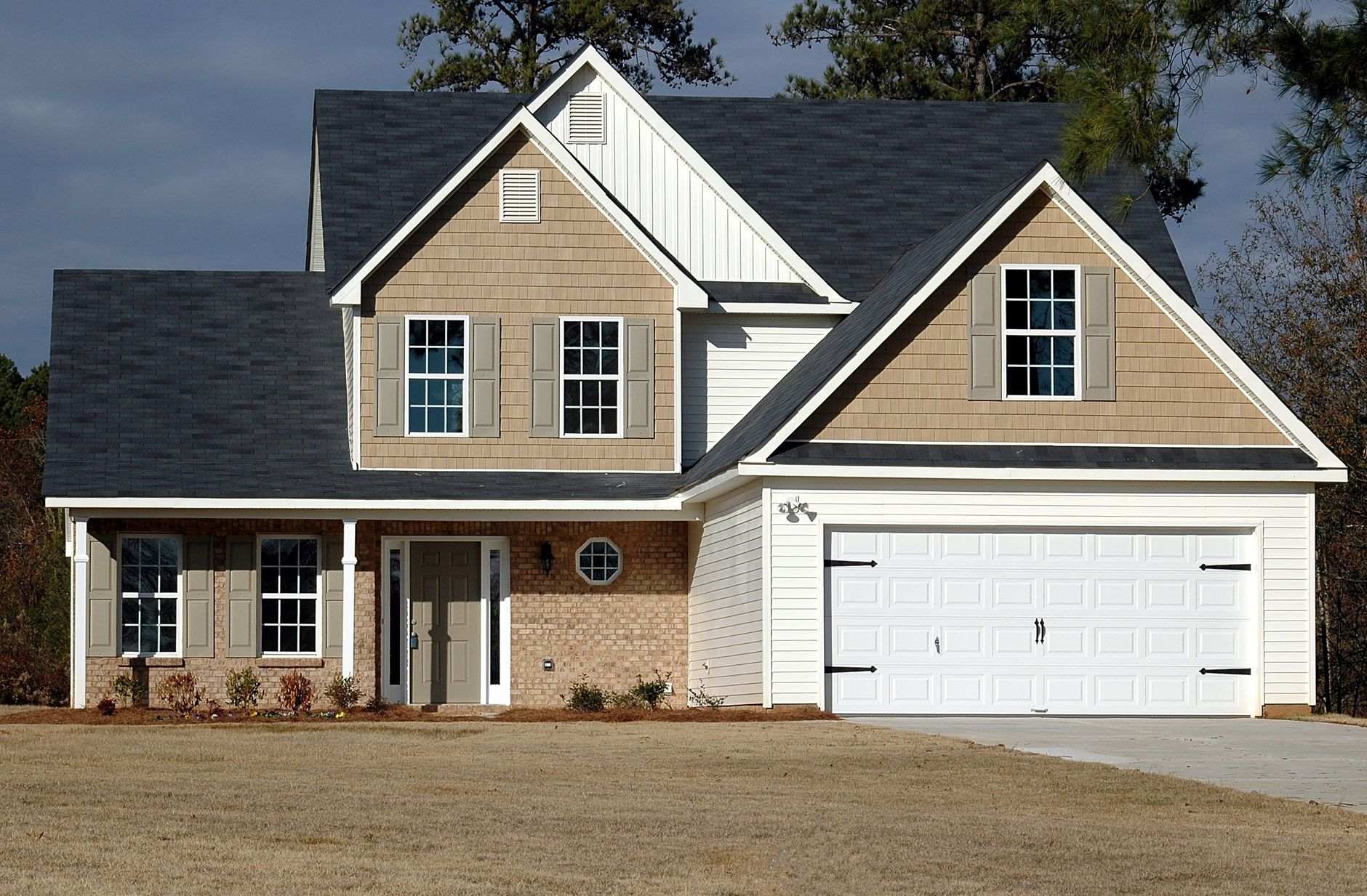 Suburban North Carolina house with tan siding on a quiet residential street